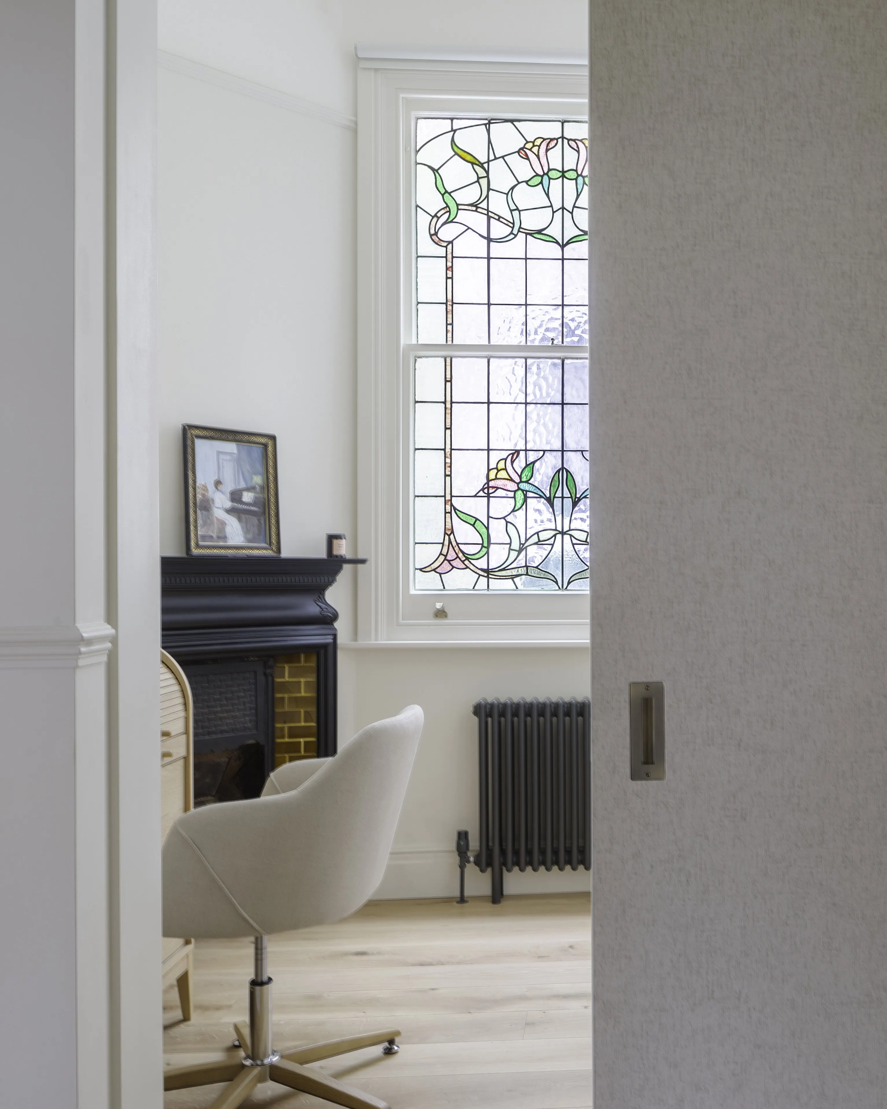 Sliding door entrance leading to bedroom suite in Belsize Park flat