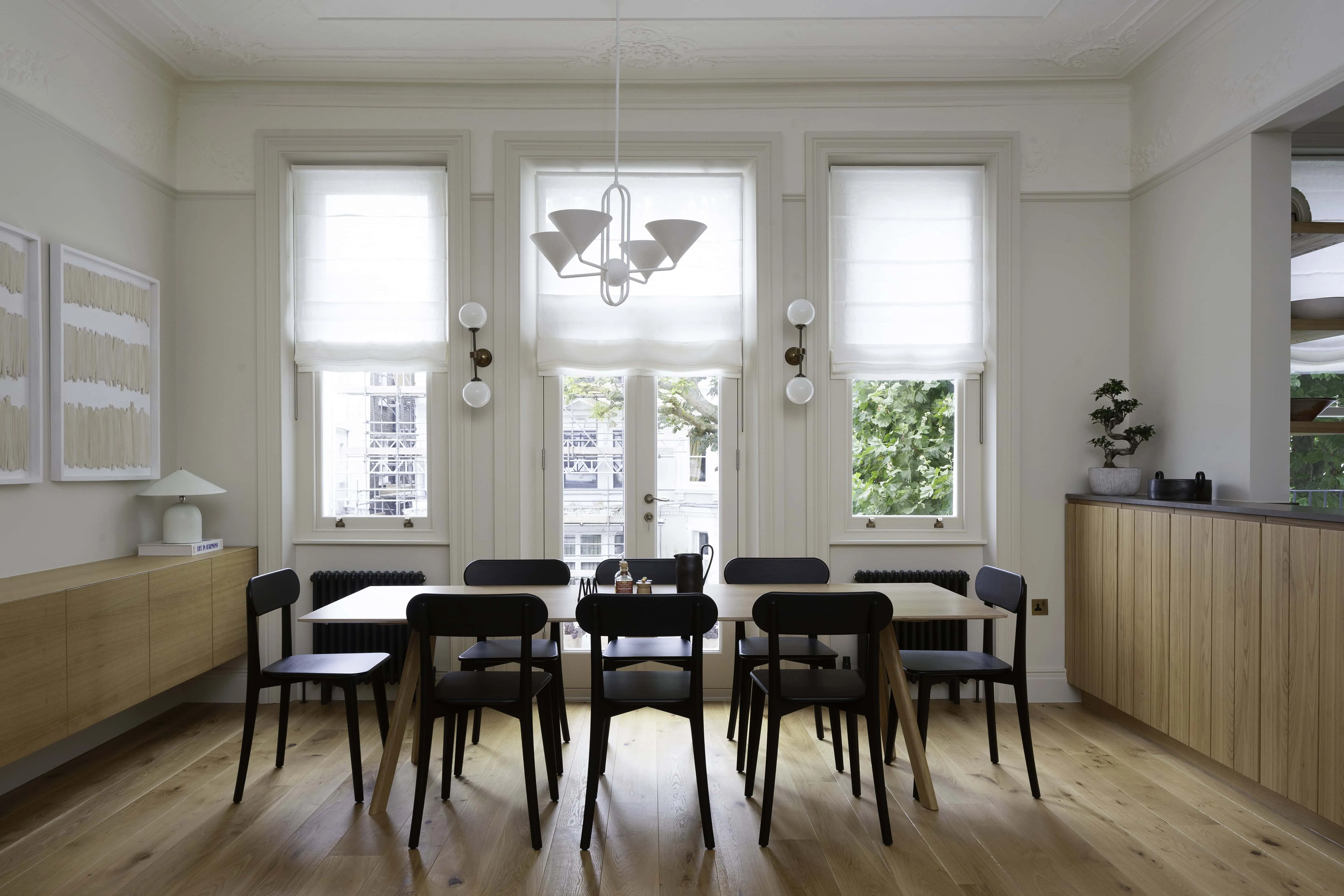 Pendant light and modern dining table in period setting in Belsize Park flat