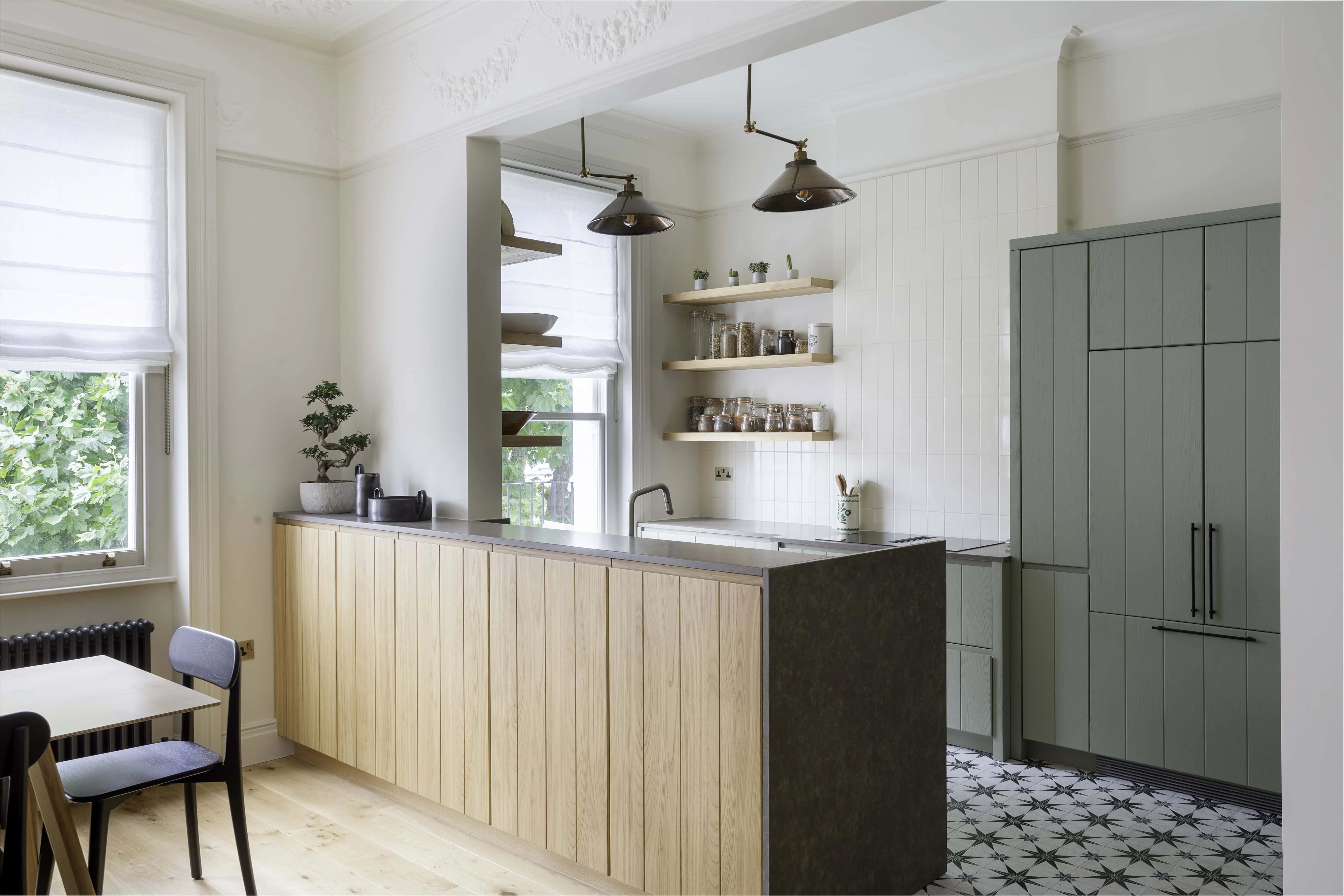 Open-plan kitchen and dining area with natural light and direct garden connection in renovated Belsize Park flat