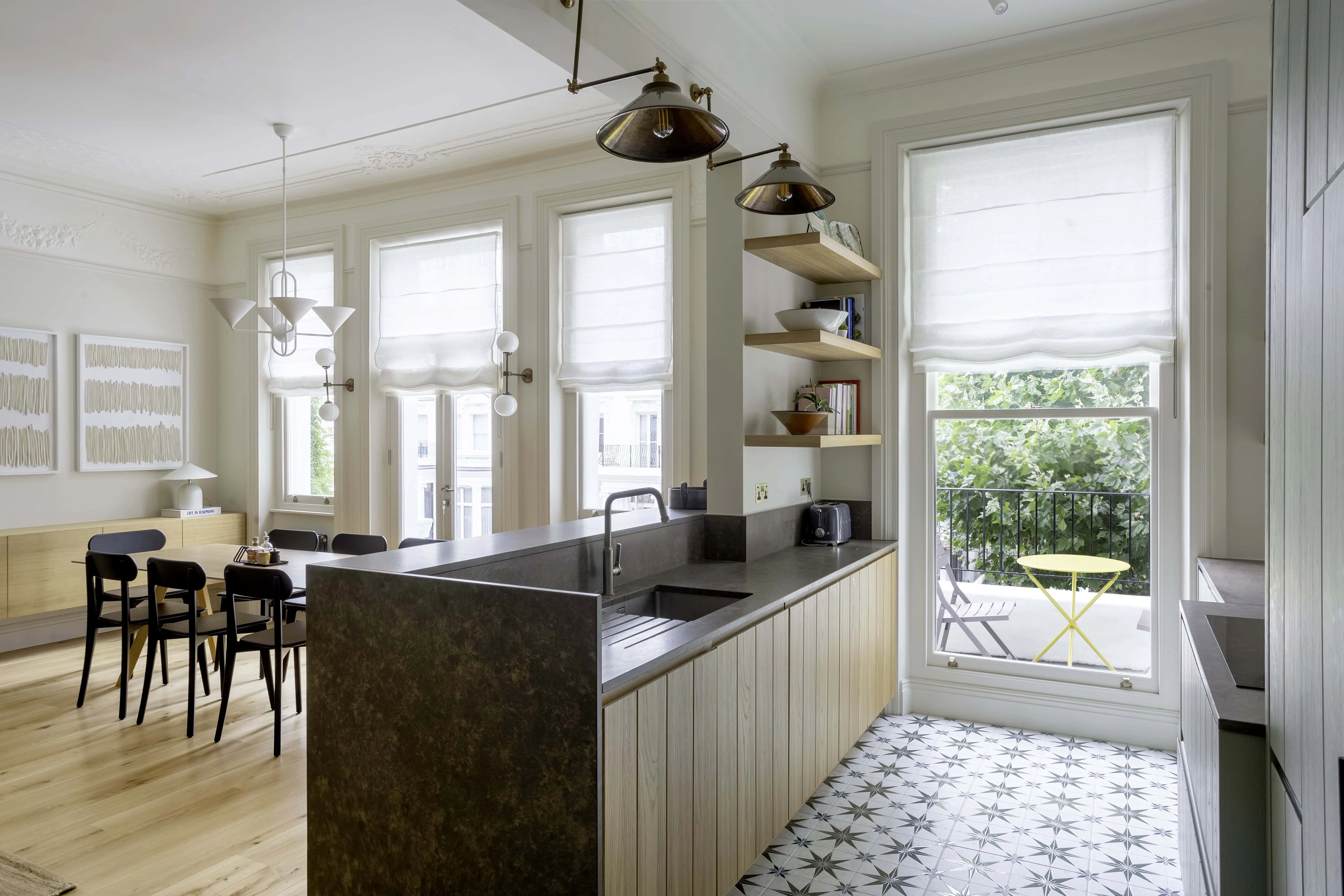 Kitchen and living overview with island and built-in storage in Belsize Park flat