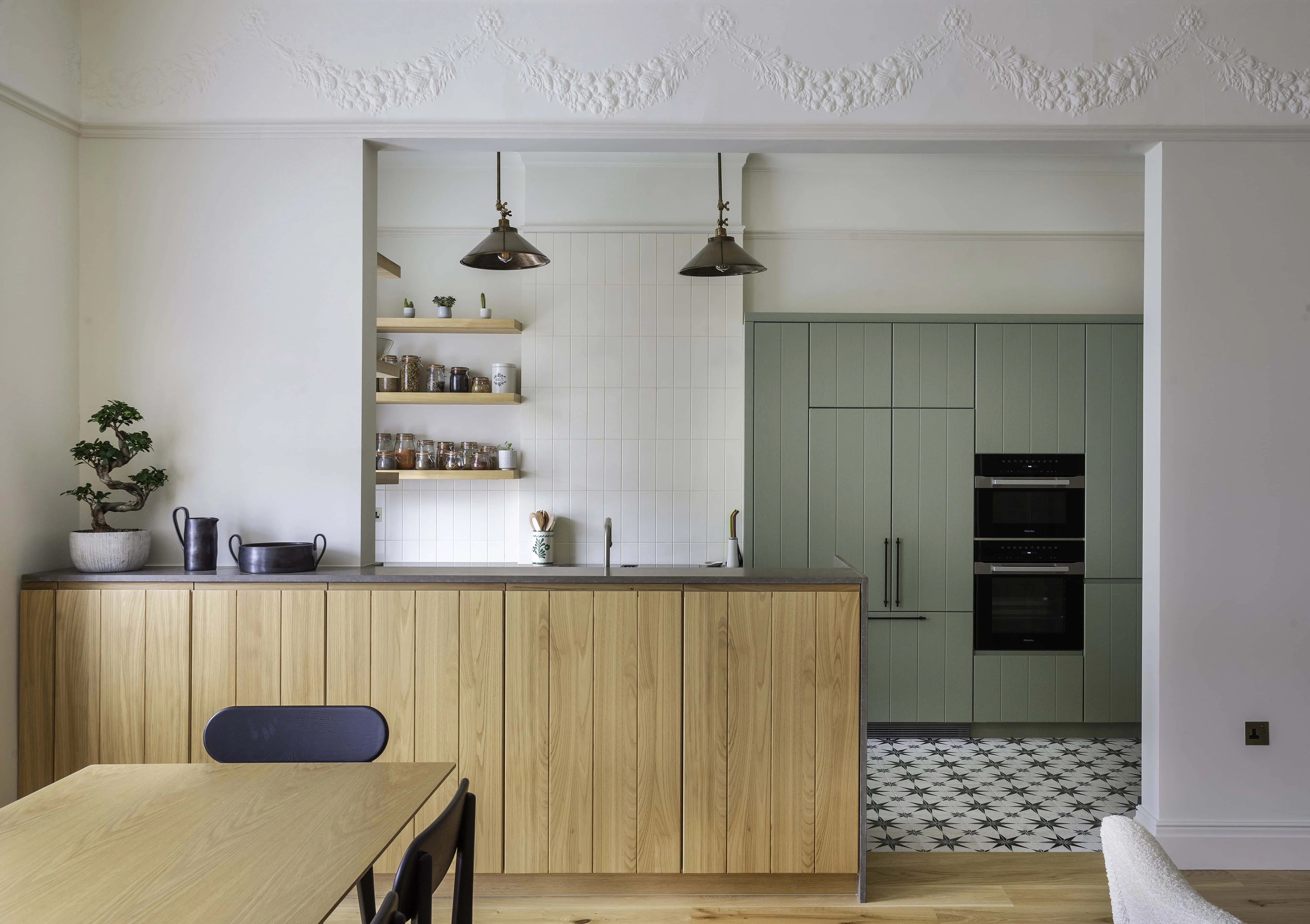 Pendant light and modern dining table in period setting in Belsize Park flat