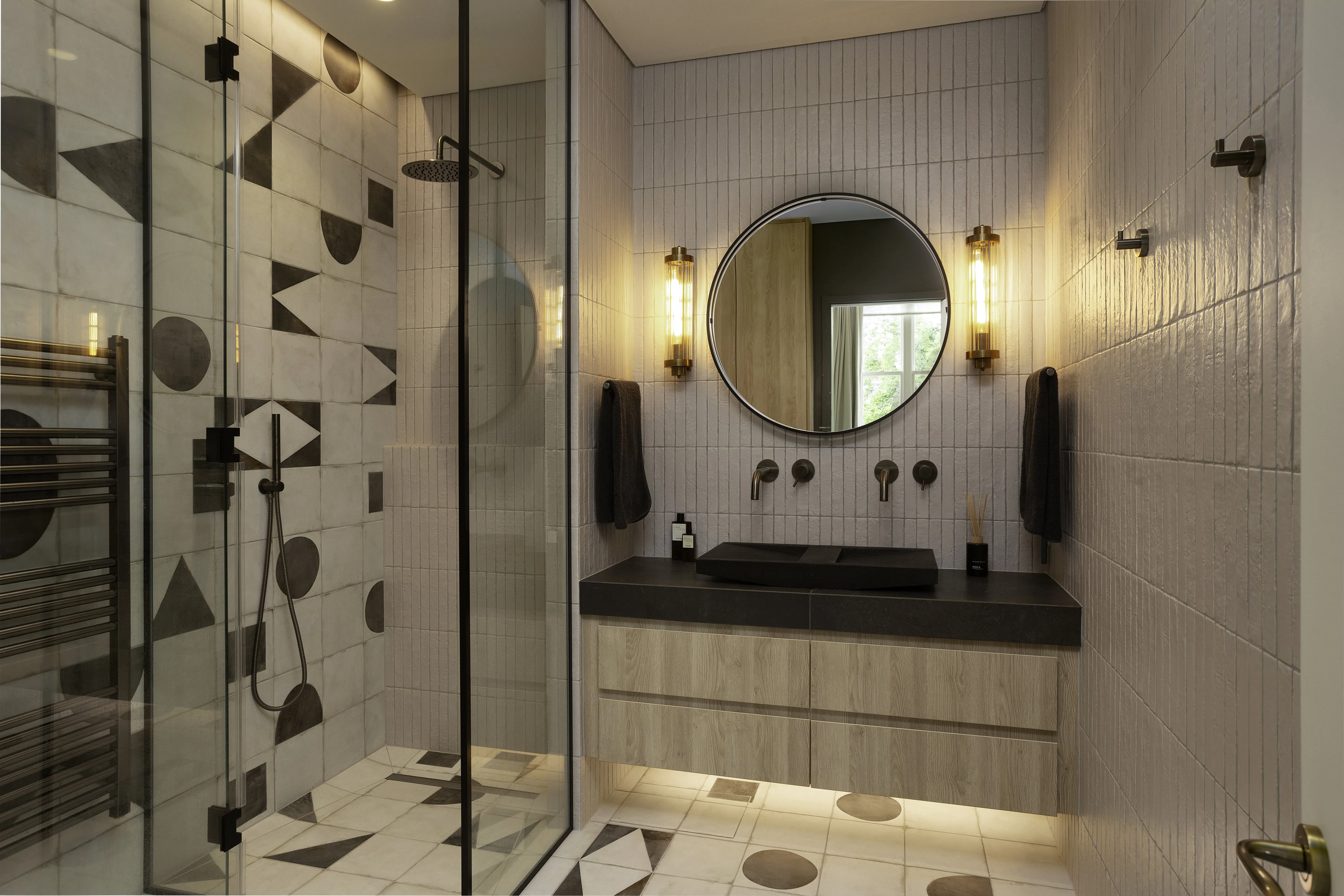 En-suite bathroom with bespoke joinery, walk-in shower, and modern fixtures in a renovated Belsize Park Victorian flat