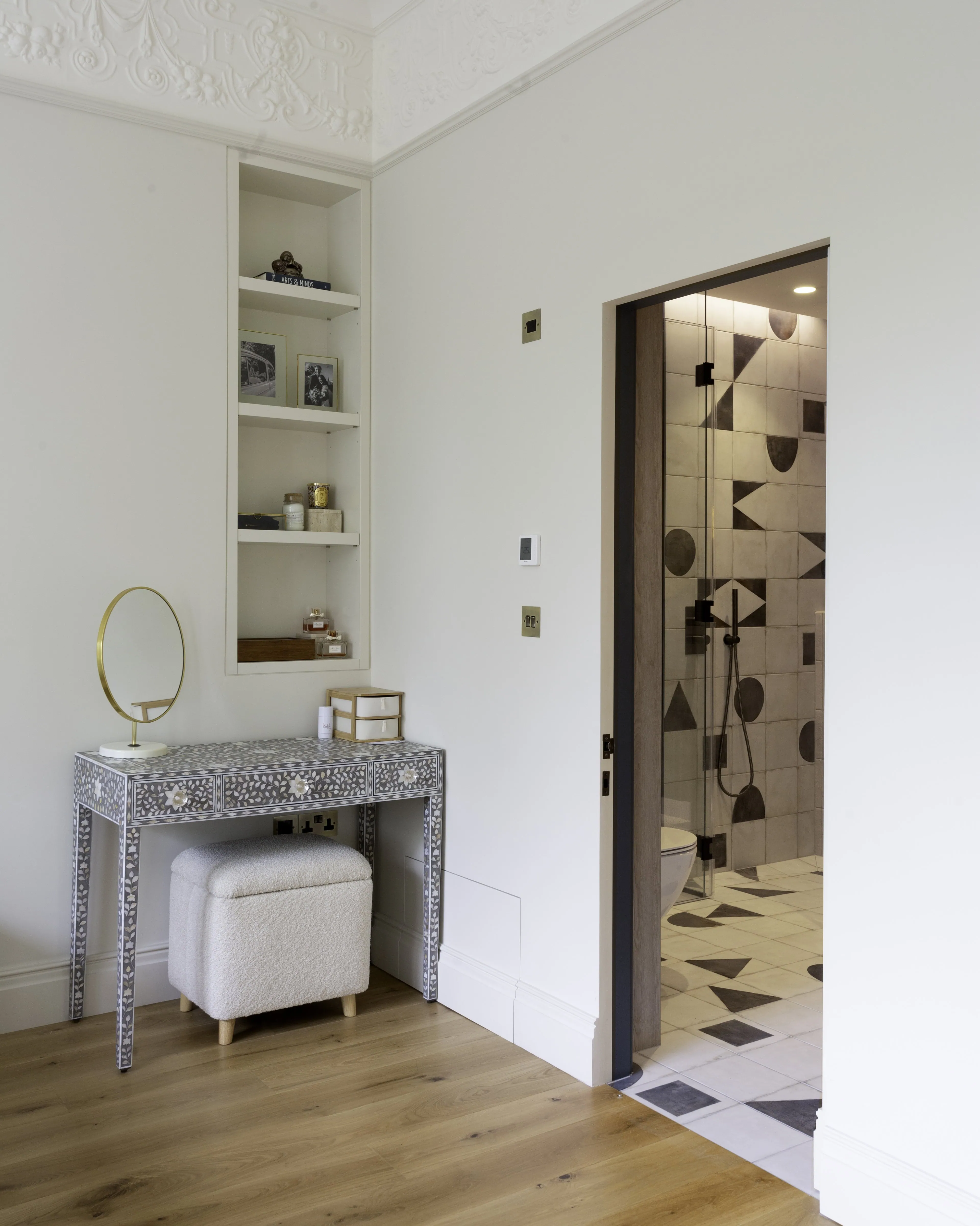 Principal en-suite featuring patterned tiled flooring and sleek modern finishes in the renovated Belsize Park flat
