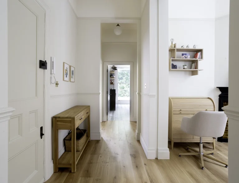 Entrance hall with bright corridor and period detailing in Belsize Park flat