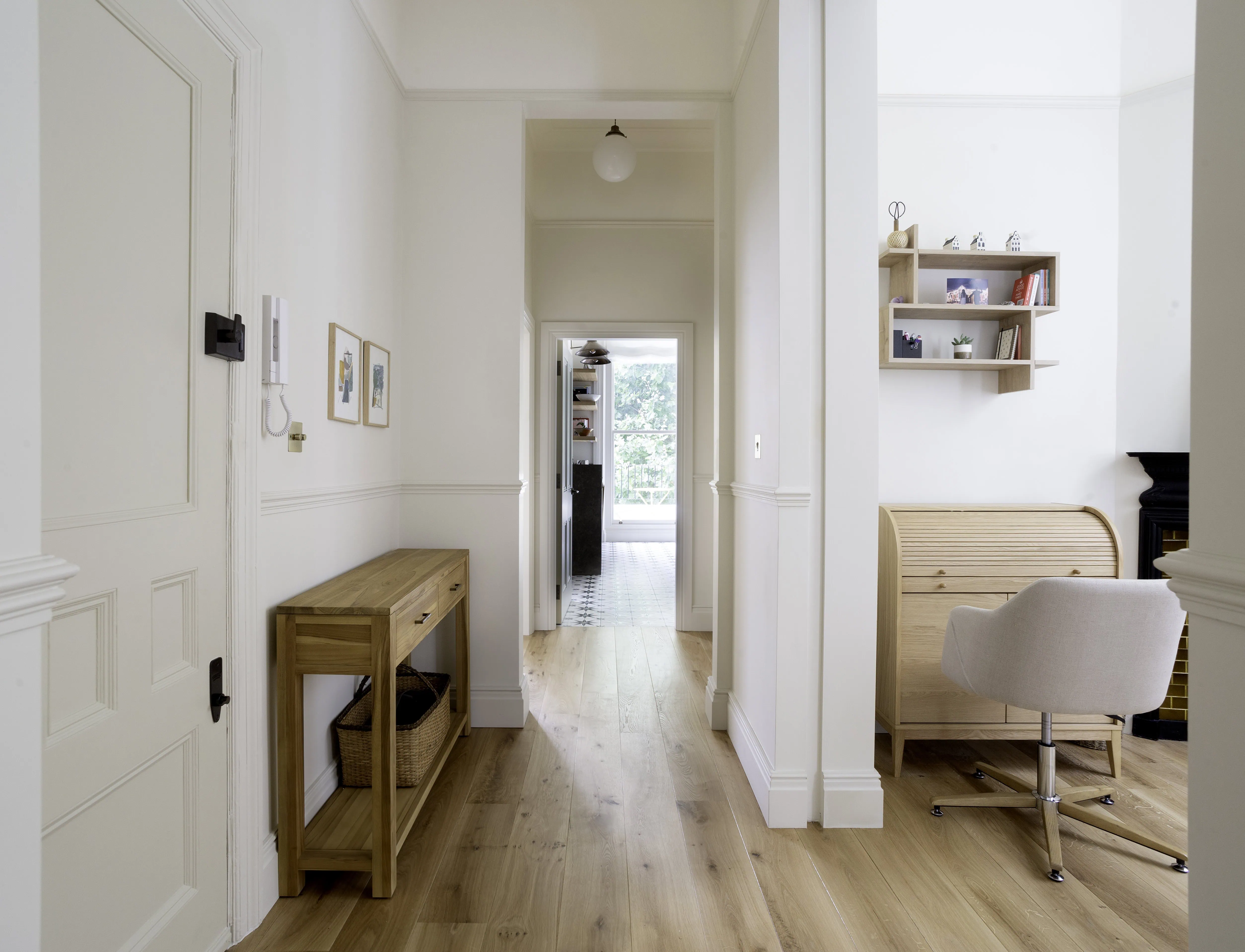 Entrance hall with bright corridor and period detailing in Belsize Park flat
