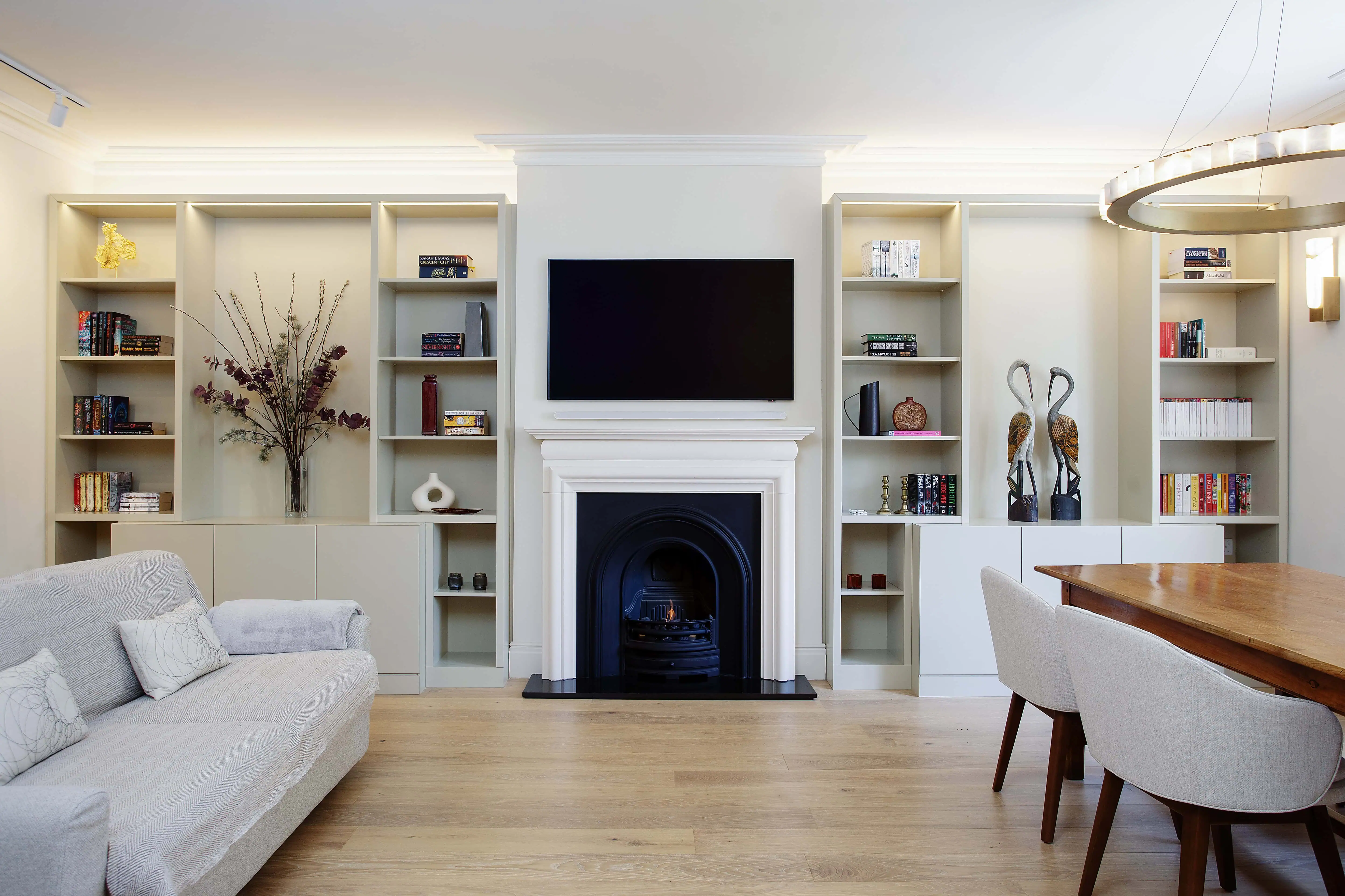 Living and dining room with fireplace and built-in shelving in a Victorian flat renovation, Hampstead