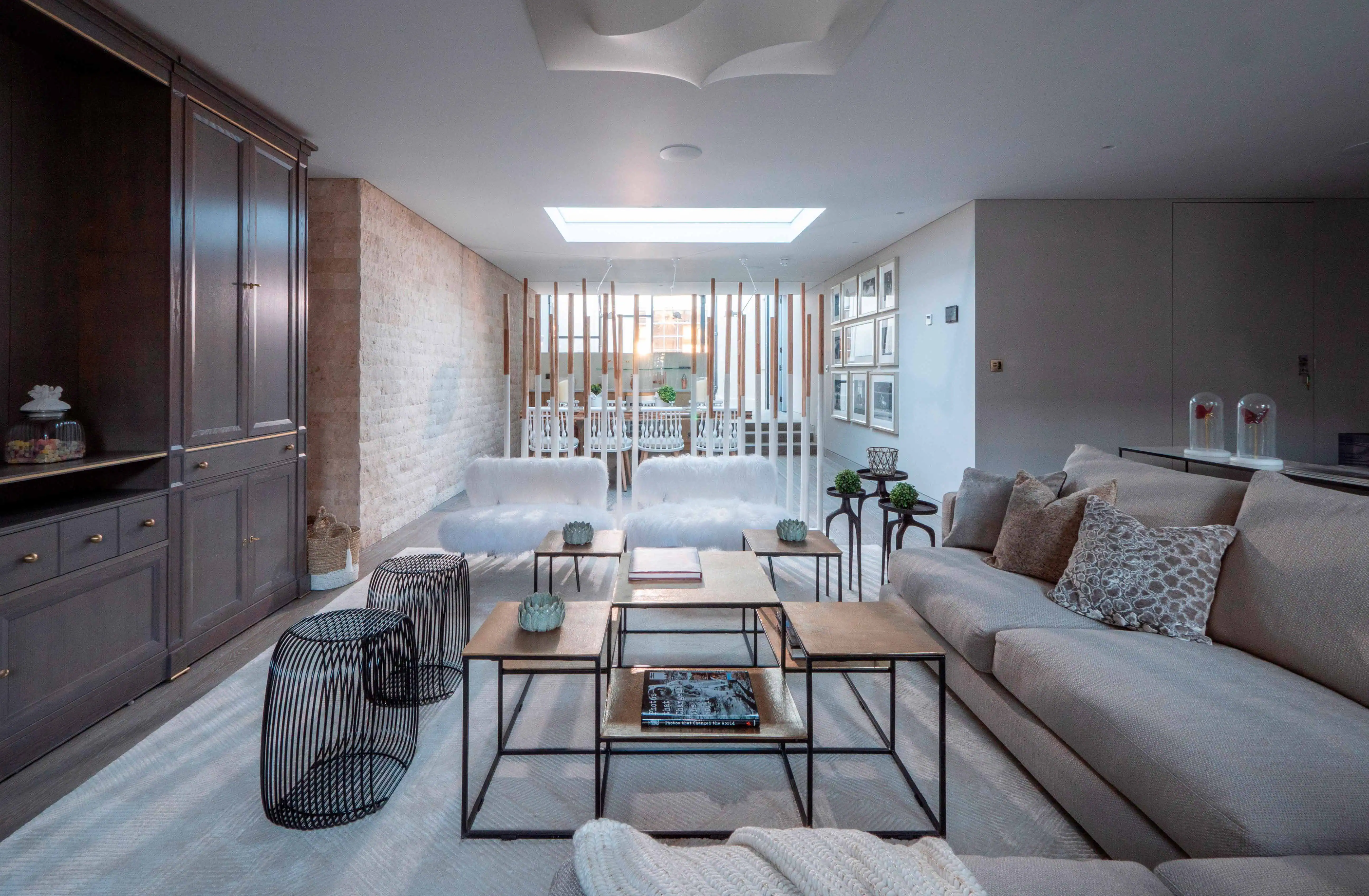 Modern open-plan living room with floor-to-ceiling glass and sleek contemporary design