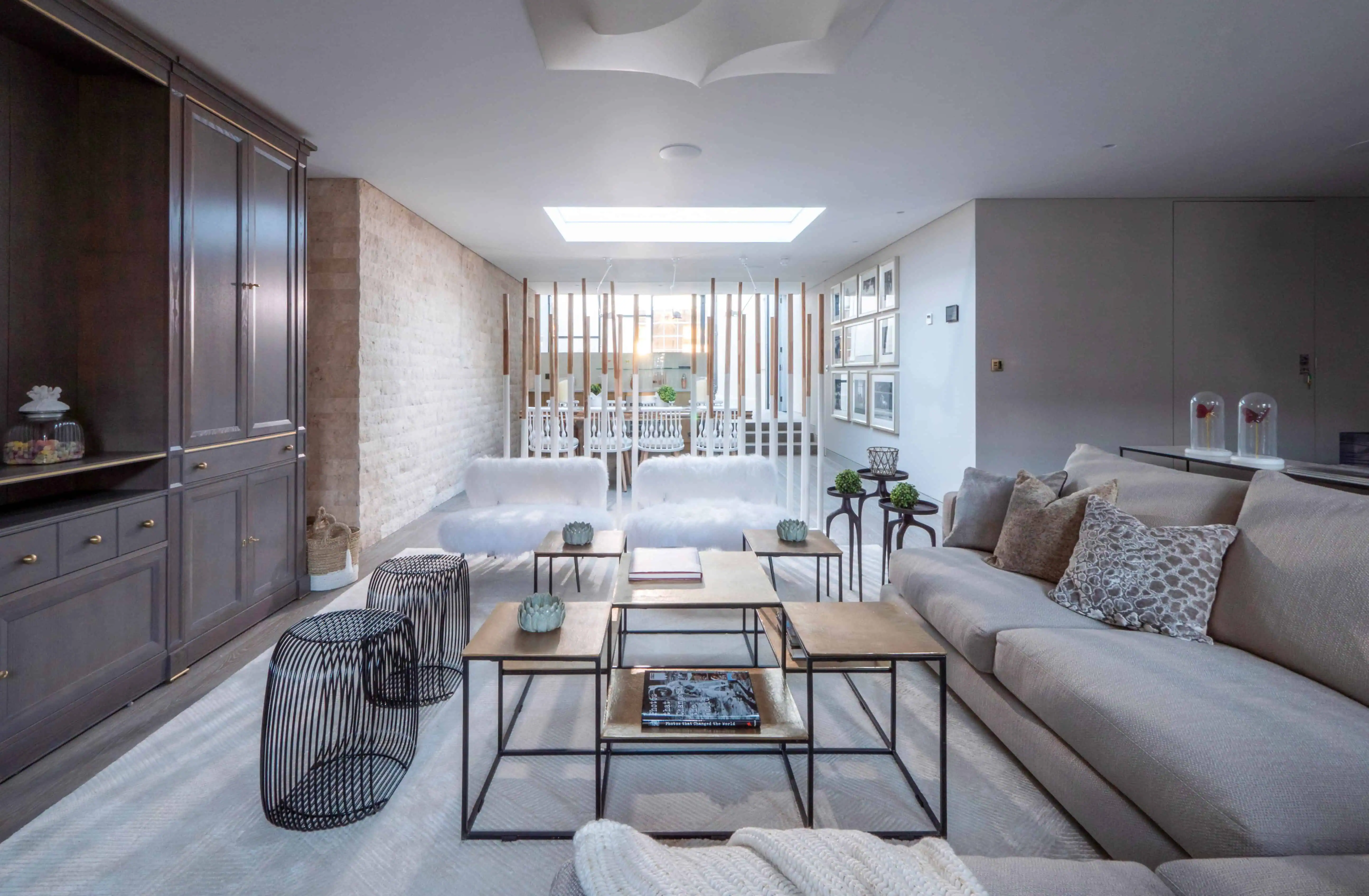 Modern open-plan living room with floor-to-ceiling glass and sleek contemporary design