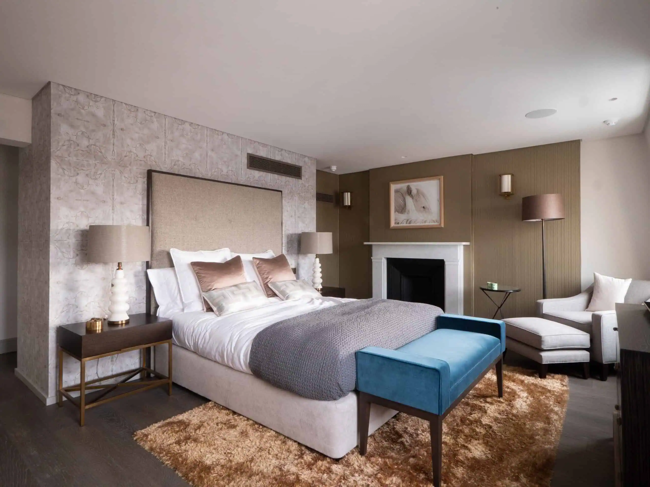 Luxury bedroom suite with warm tones and layered textiles for comfort.