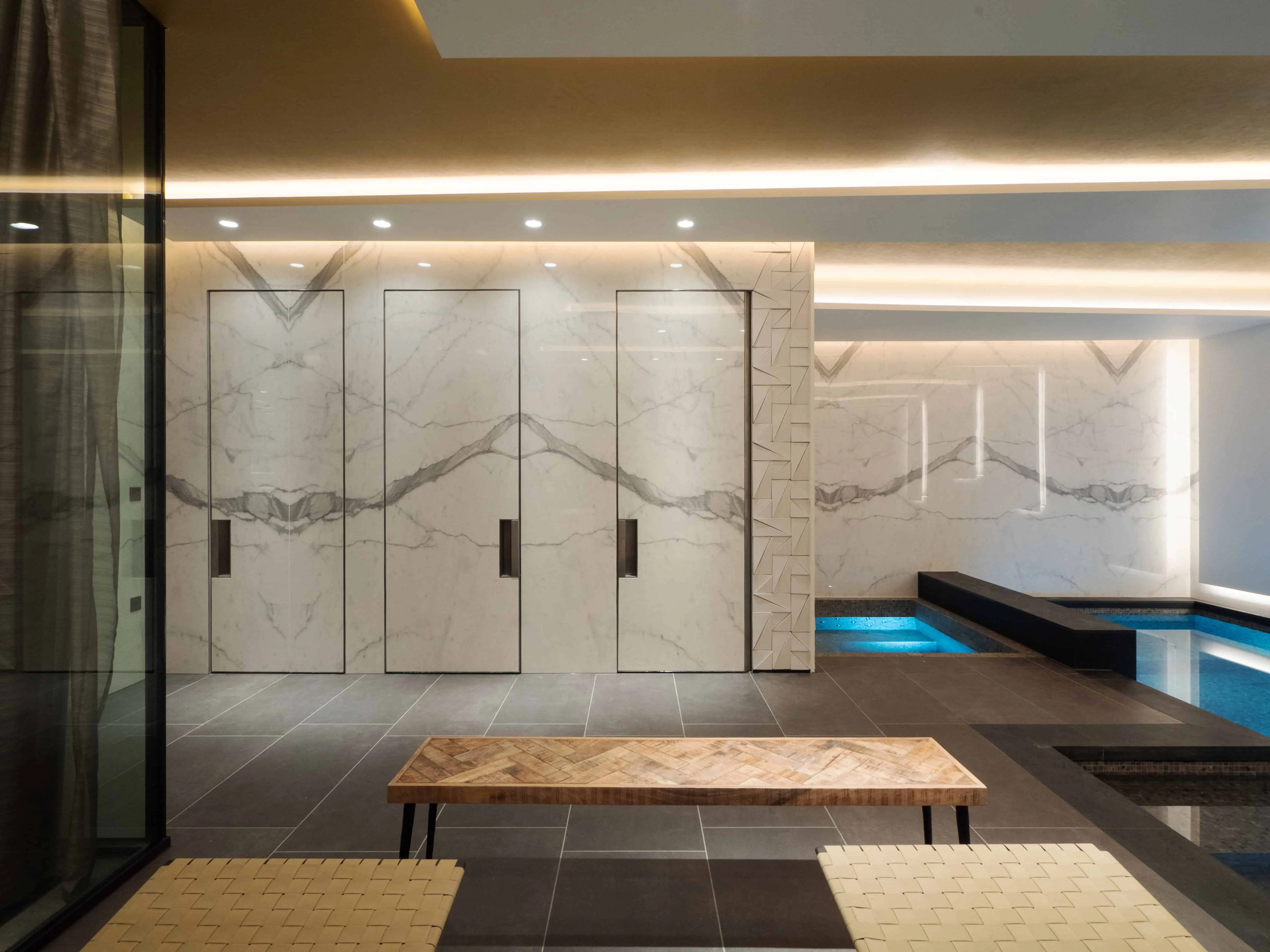 Opulent marble Spa area with recessed lighting and bespoke cabinetry