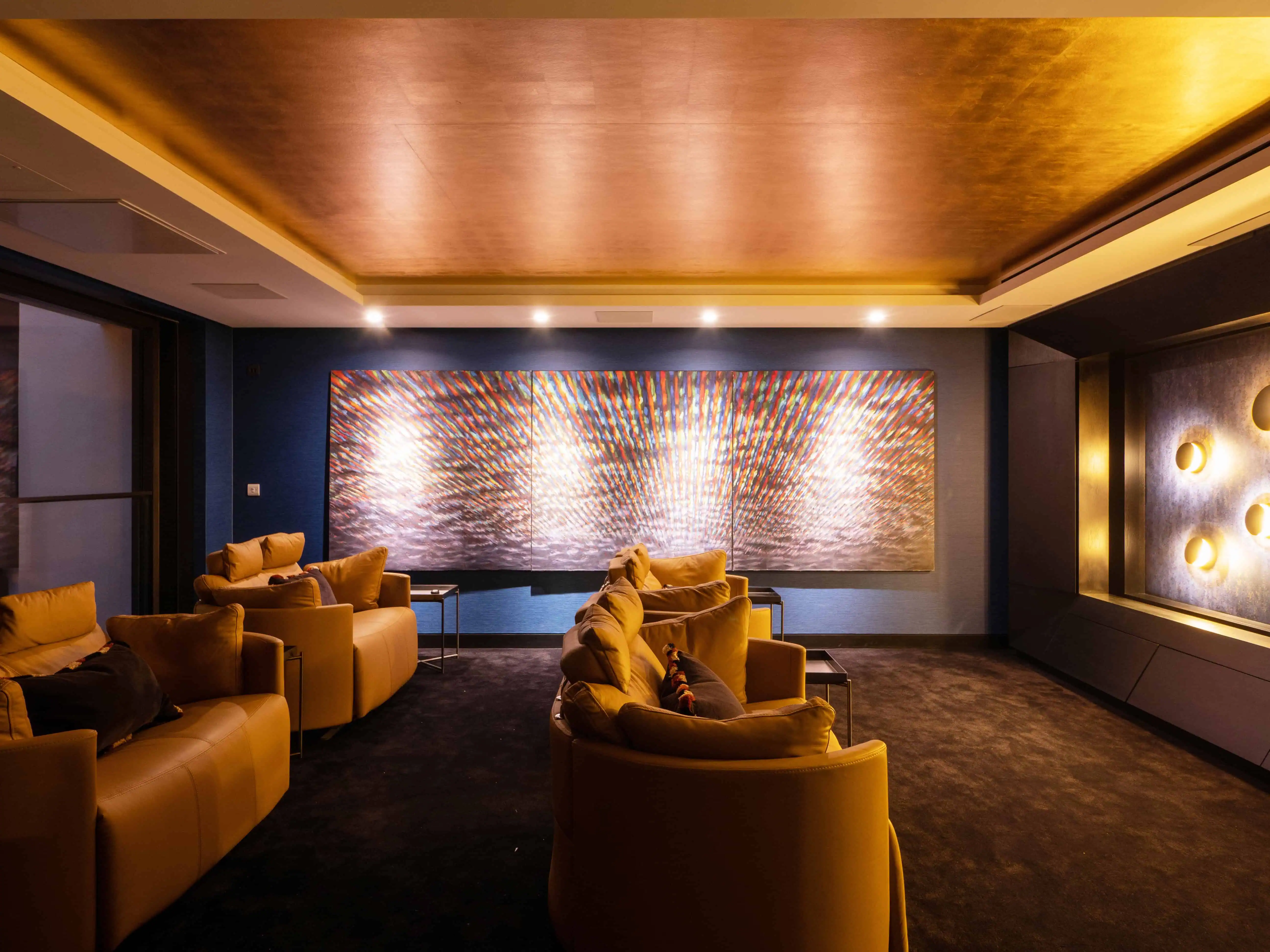 Sophisticated formal lounge with dark tones, brass accents, and statement lighting.