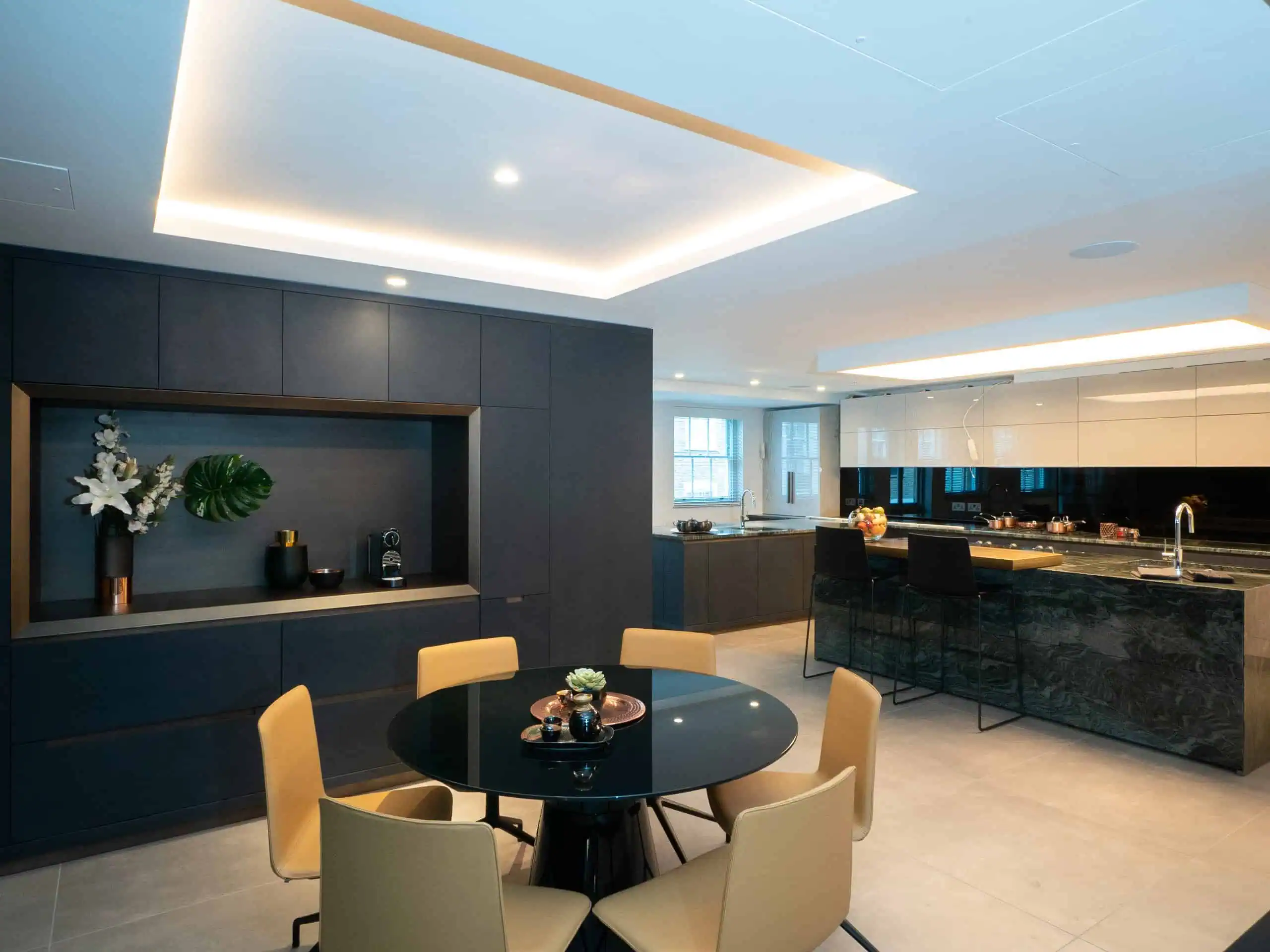 Contemporary breakfast area with sculptural ceiling lights and seamless indoor-outdoor flow.
