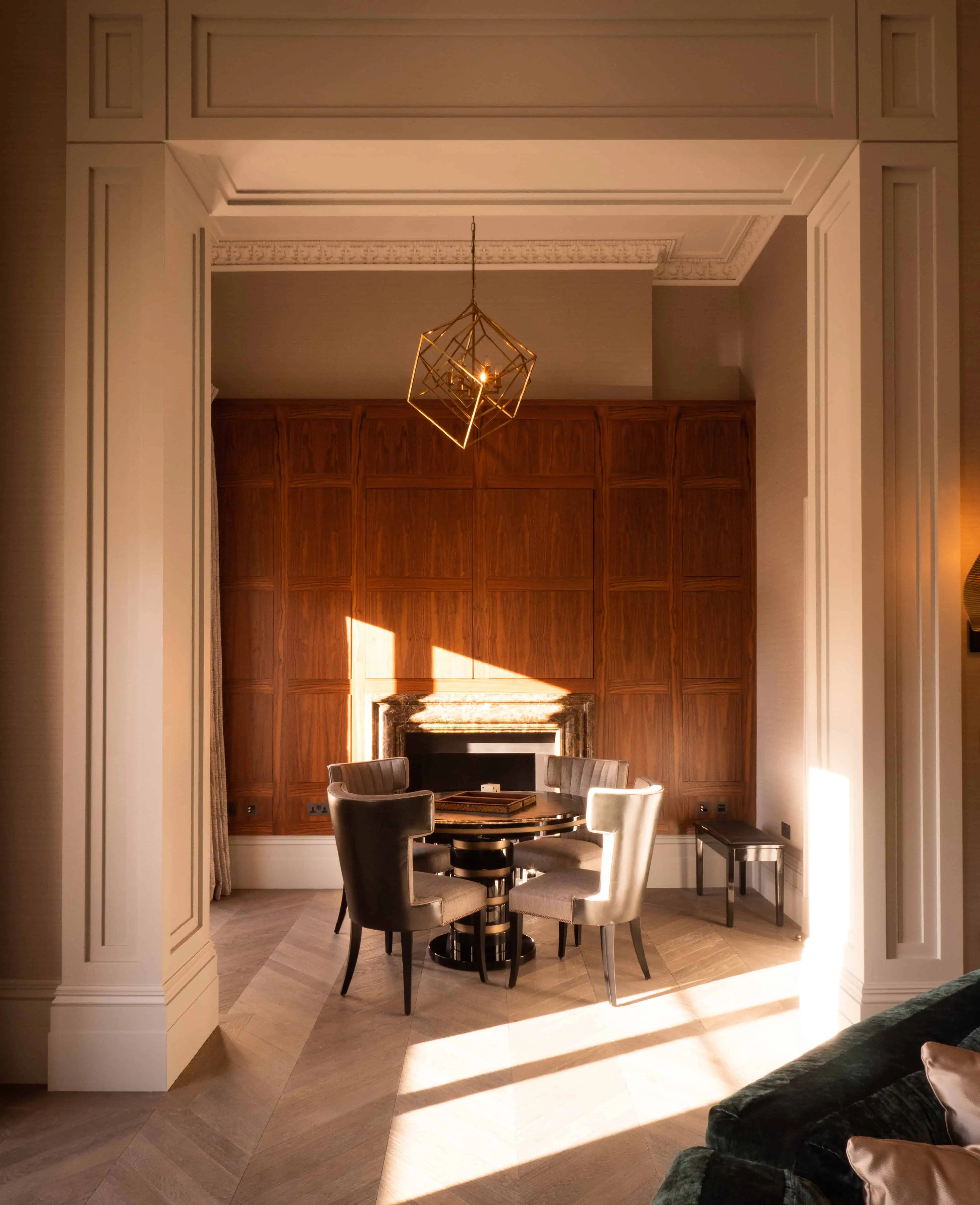 Refined poker room corner with tall wall panelling and warm wood finishes.