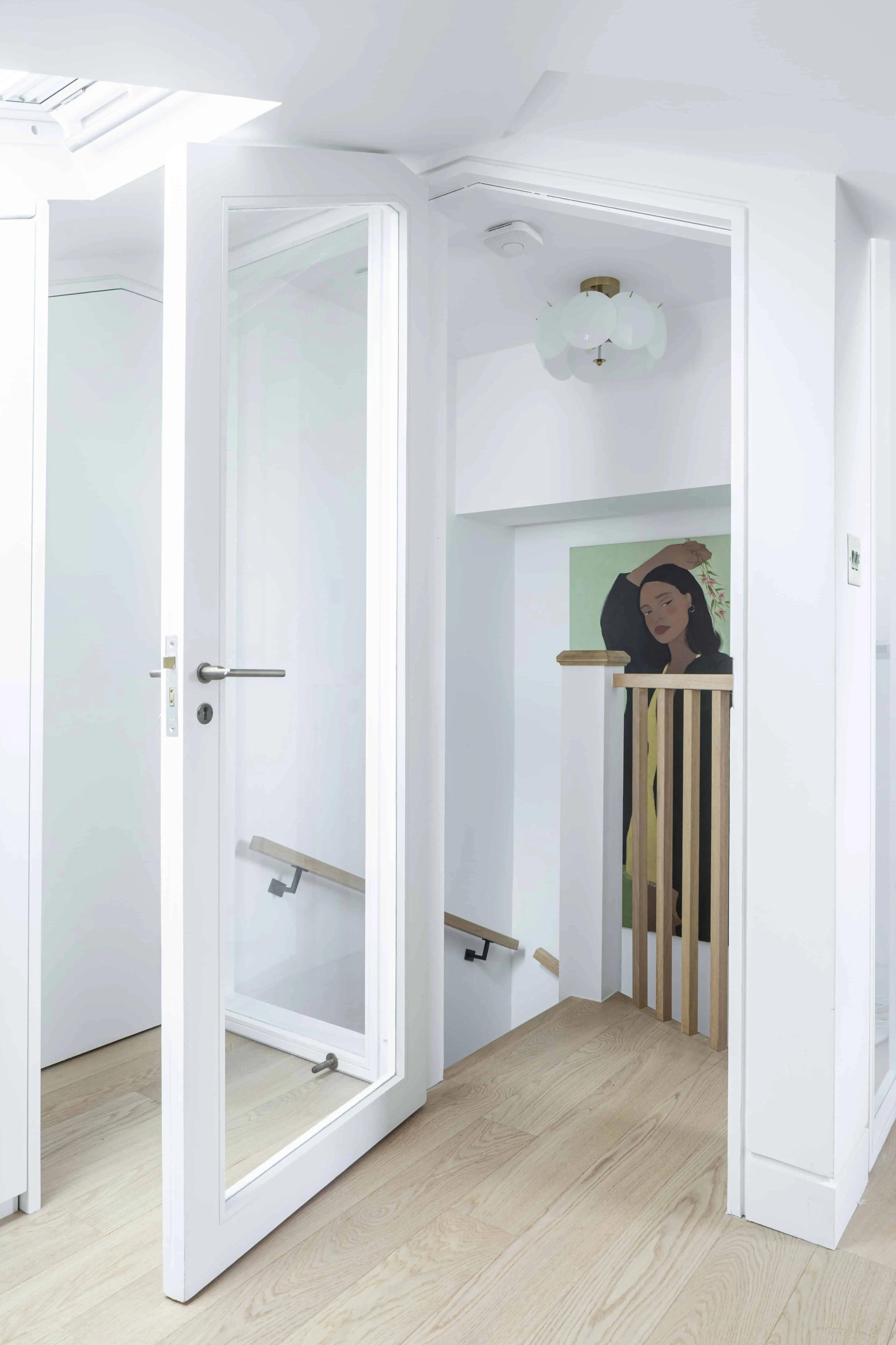 Glass door with staircase view in Victorian maisonette renovation, Primrose Hill