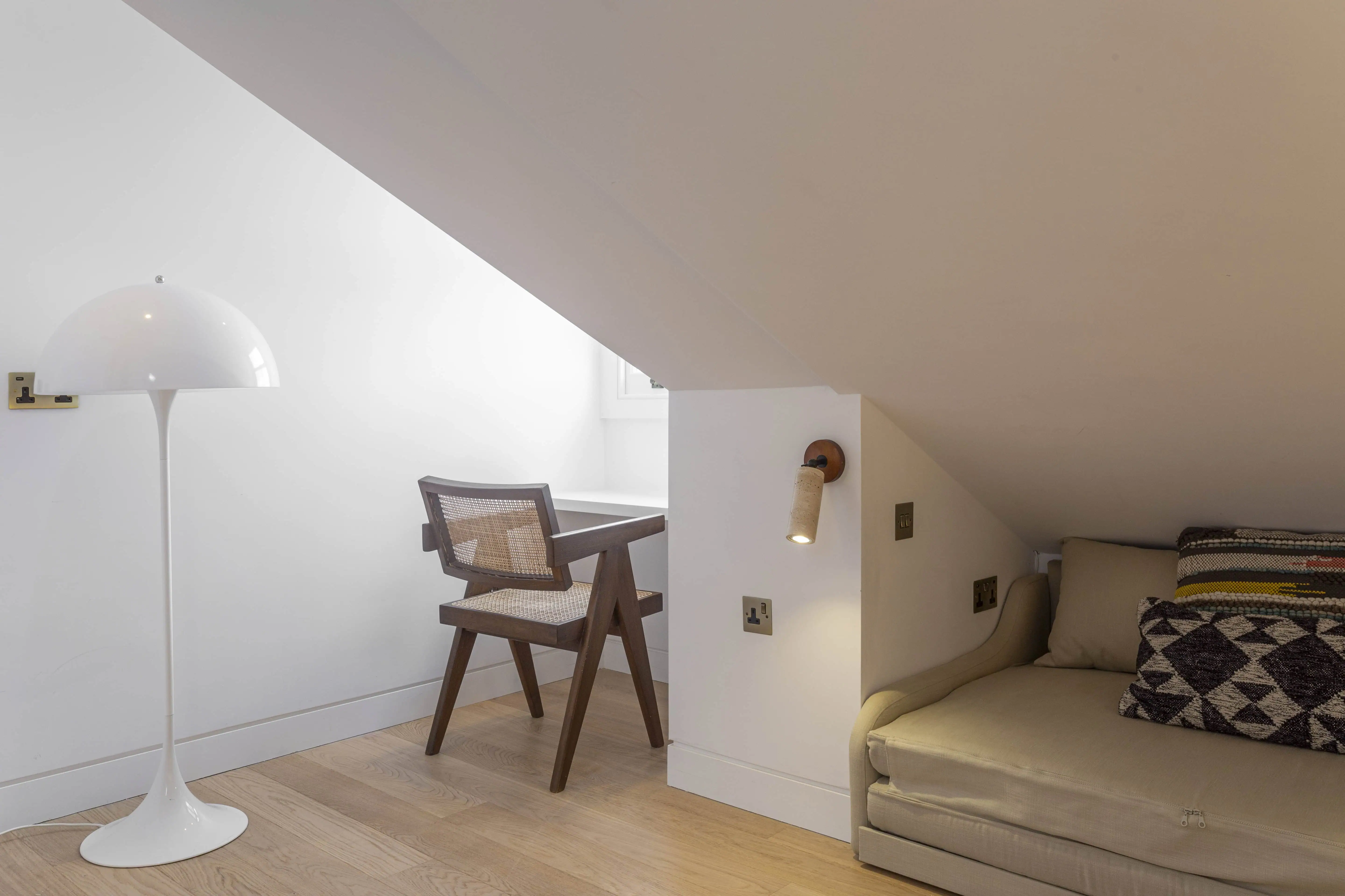 Loft bedroom with sloped ceiling in Victorian maisonette renovation, Primrose Hill