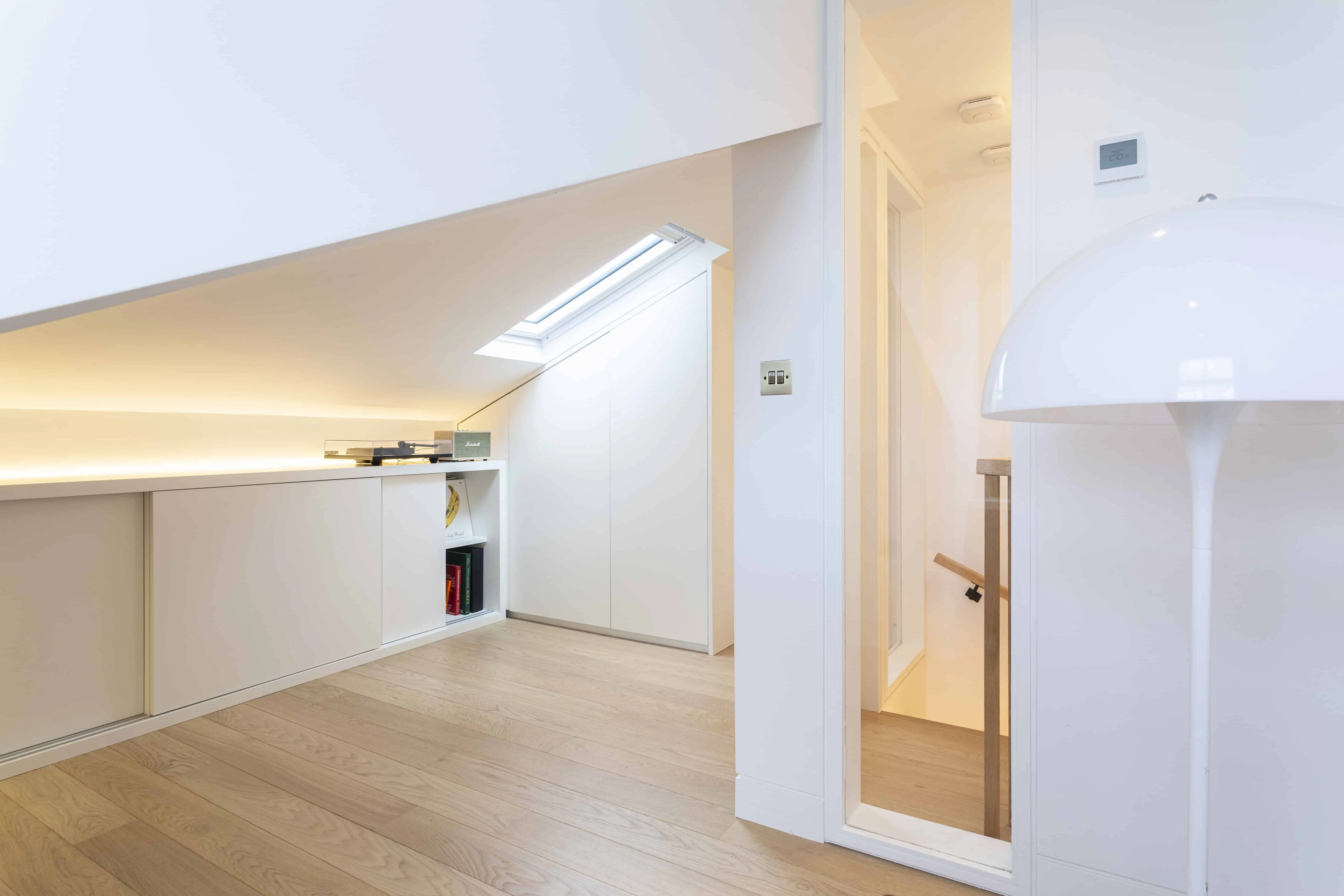 Loft bedroom with sloped ceiling in Victorian maisonette renovation, Primrose Hill