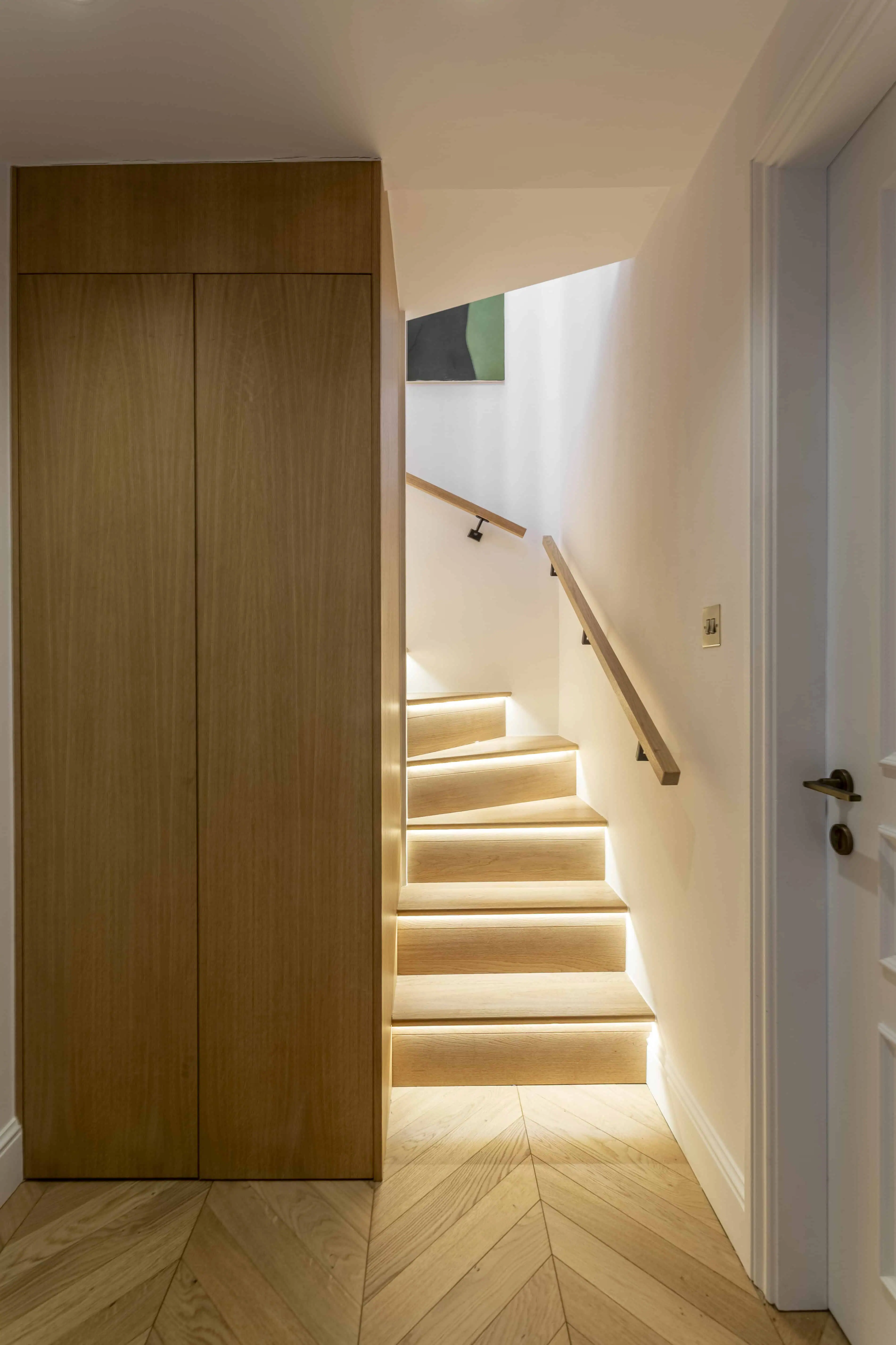 Staircase with built-in timber storage in Victorian maisonette renovation, Primrose Hill