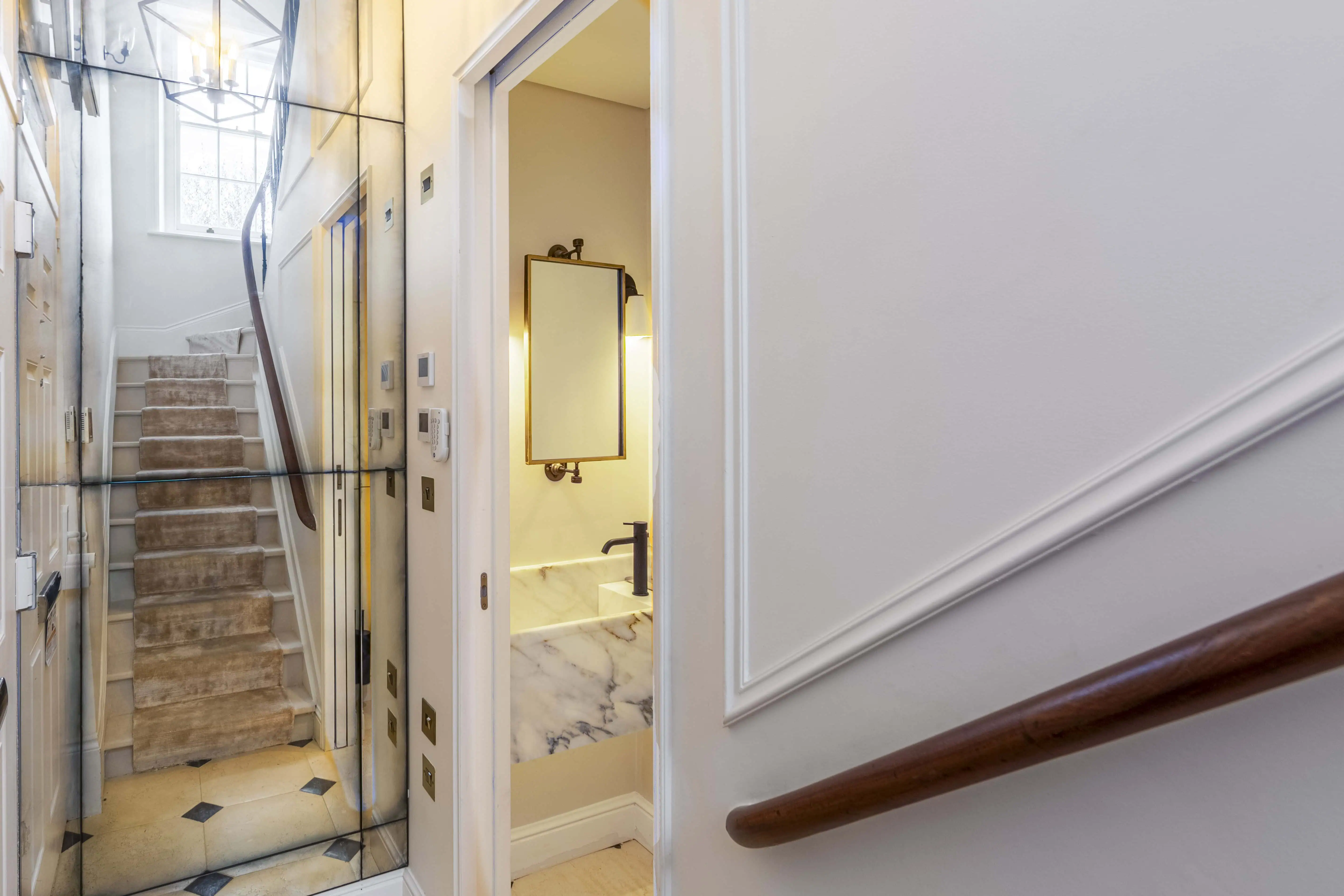 Antique mirror panelling with a glimpse of the guest toilet in Victorian maisonette renovation, Primrose Hill