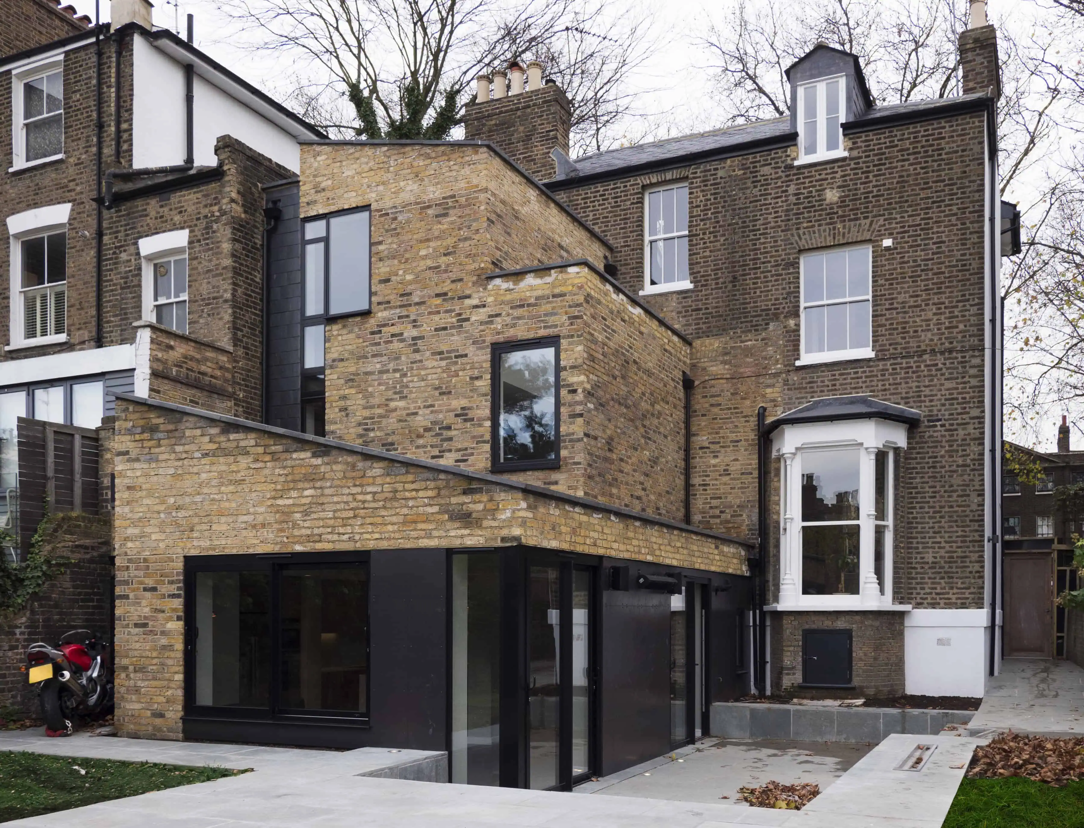 Rear extension with brick and black-framed glazing in a Hackney modern extension