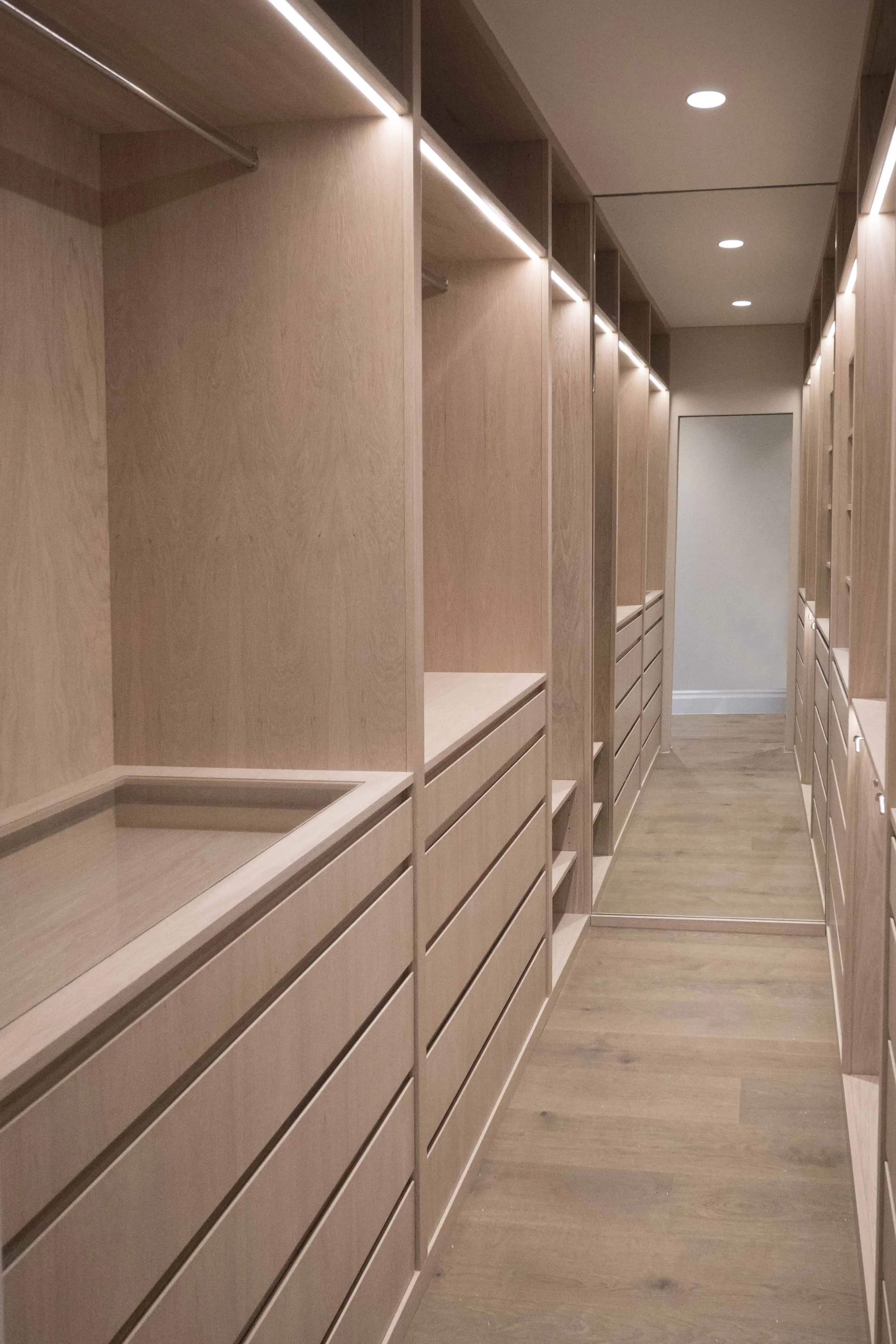 Walk-in closet with built-in wardrobes in a Hackney modern extension