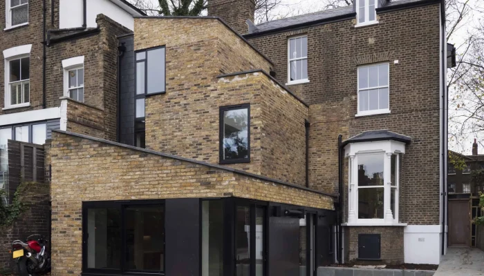 Rear extension with brick and black-framed glazing in a Hackney modern extension